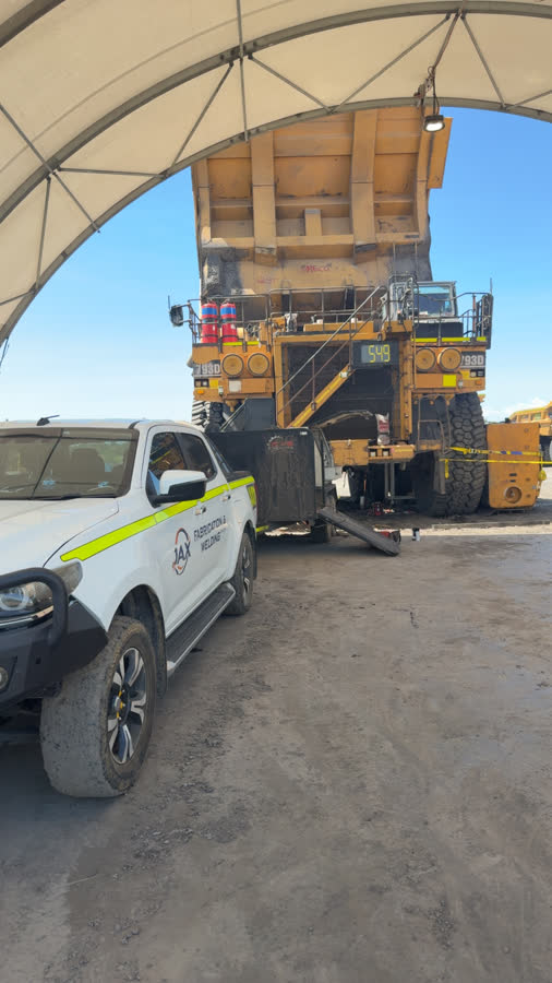 JAX Fabrication vehicle alongside a CAT 793D haul truck undergoing maintenance